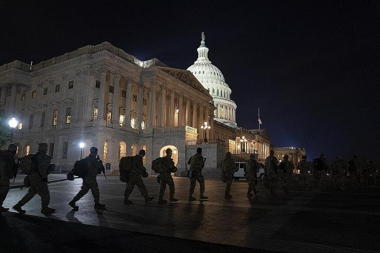 Members of the National Guard at the US Capitol in Washington on Monday. Threats by radical groups ahead of President-elect Joe Biden's inauguration today have triggered a massive security response in Washington and other state capitals.