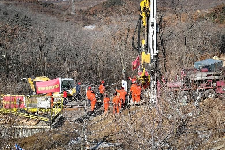 Rescuers at the site of a gold mine explosion in Shandong province. Two top officials have been axed over the incident. PHOTO: AGENCE FRANCE-PRESSE