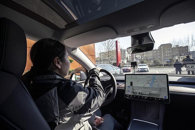 A sales assistant driving Tesla's Model Y electric vehicle in Shanghai this month. The market leader in China for electric vehicles is American firm Tesla, which entered the country in 2018 and increased its hold after getting the green light to buil