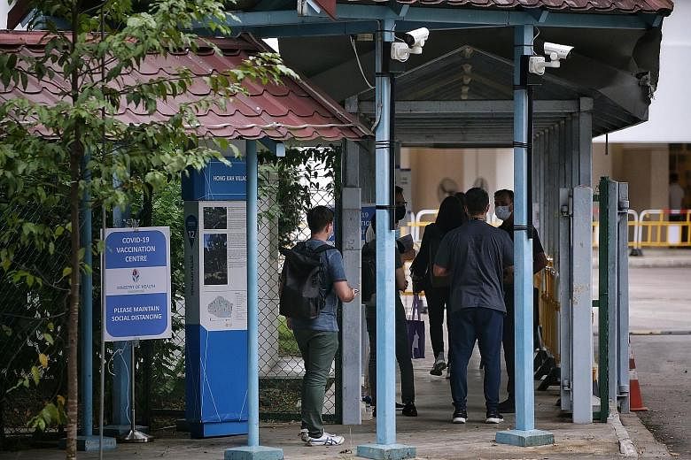 Front-line workers entering the former Hong Kah Secondary School, which is now being used as a Covid-19 vaccination centre, yesterday. Cleaners and nurses were among those who received the jabs. The Health Ministry tender for new centres comes as vac