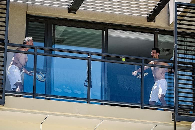 World No. 1 Novak Djokovic playing tennis with a support staff member on a balcony at M Suites in Adelaide, where they are quarantined ahead of the Australian Open. In contrast in Melbourne, more than 70 players and their entourage are confined to th