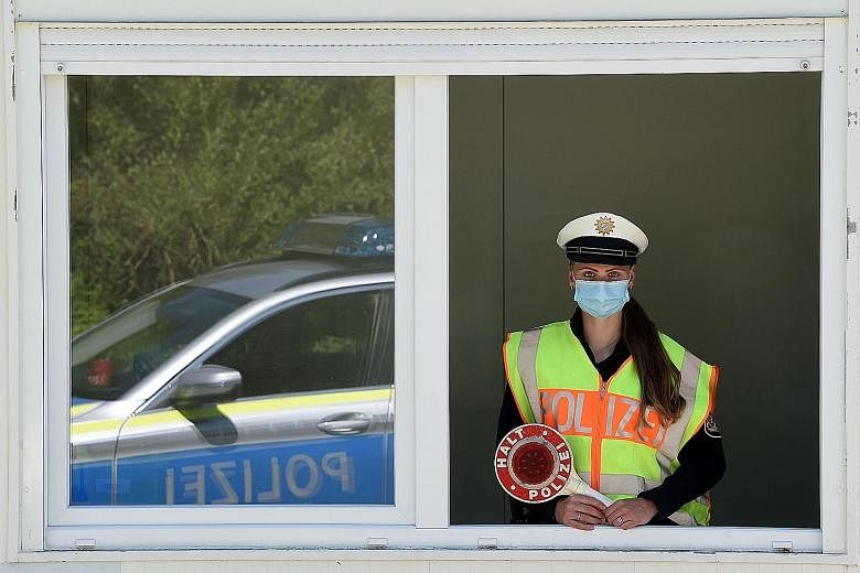 A police officer at the Bavarian-Austrian border crossing in Oberaudorf, Germany, last May. The number of coronavirus cases in Germany has hit 2,068,002. PHOTO: AGENCE FRANCE-PRESSE