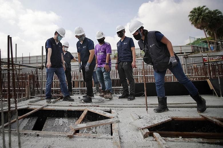 Senior Minister of State for Manpower Zaqy Mohamad (front, second from left), together with safety inspectors from the Ministry of Manpower's occupational safety and health division, inspecting the worksite of Affinity at Serangoon condominium yester