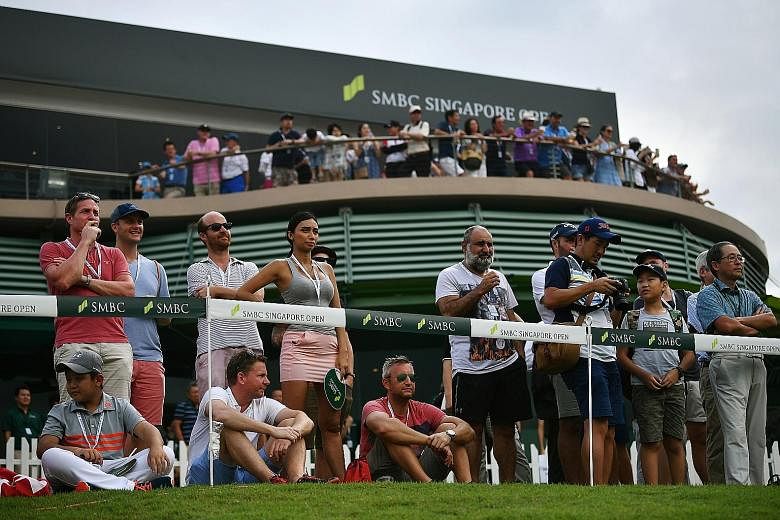 Left: Matt Kuchar during the final round of the SMBC Singapore Open at Sentosa's Serapong Course last year. The American, who won the event, was playing in Singapore for the first time. Below: Spectators viewing the action at the Sentosa Pavilion nea