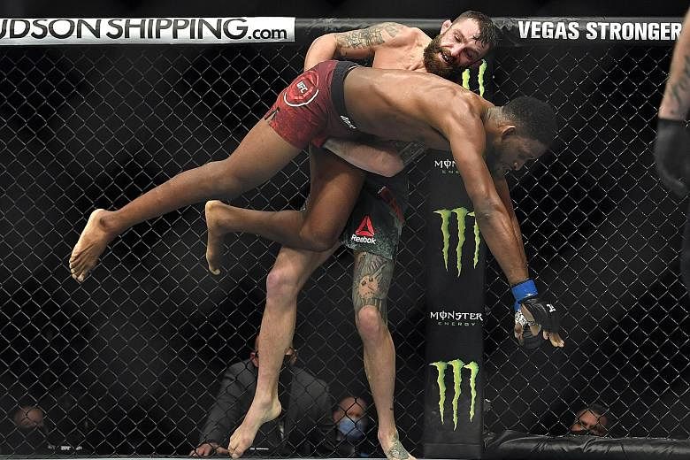 Michael Chiesa lifting Neil Magny off the ground during their welterweight bout in Abu Dhabi on Wednesday. Chiesa won the UFC Fight Night main event via unanimous decision (49-46, 49-46, 49-46) with a dominant display over five rounds.