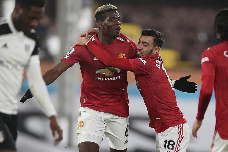 Manchester United's Paul Pogba (far left) celebrating his winner with fellow midfielder Bruno Fernandes in their 2-1 Premier League win over Fulham on Wednesday. The victory meant that the Red Devils are back on top of the table, two points ahead of 