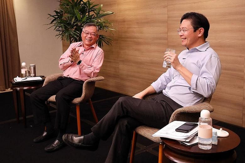 Health Minister Gan Kim Yong and Education Minister Lawrence Wong, who co-chair the Covid-19 task force, at a media conference on Tuesday to mark one year of the Covid-19 battle in Singapore. PHOTO: LIANHE ZAOBAO