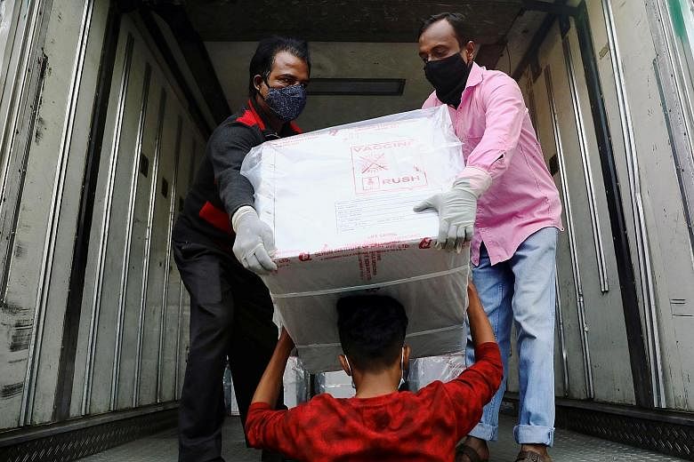 Workers in Dhaka unloading AstraZeneca Covid-19 vaccines which had arrived from India as a gift to Bangladesh yesterday. Covax, a global scheme co-led by the World Health Organisation, wants to deliver at least two billion Covid-19 vaccine doses acro