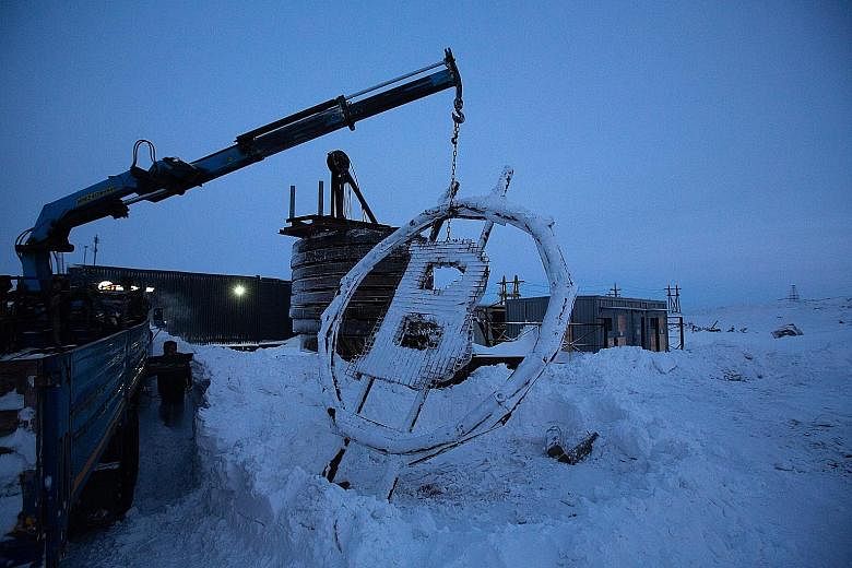 A bitcoin sculpture made from scrap metal being installed outside the BitCluster cryptocurrency mining farm in Norilsk, Russia, last month. Bitcoin slid as much as 7.7 per cent to about US$28,818 in Asian trading before steadying just above US$30,000
