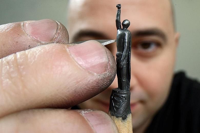 GRAPHITE IMAGES:Miniature sculptures (above) on graphite pencils by self-taught artist Jasenko Djordjevic (left). Born in Tuzla, Bosnia and Herzegovina, Djordjevic - who goes by the pseudonym Toldart - uses nothing but hand precision and a sharp knif