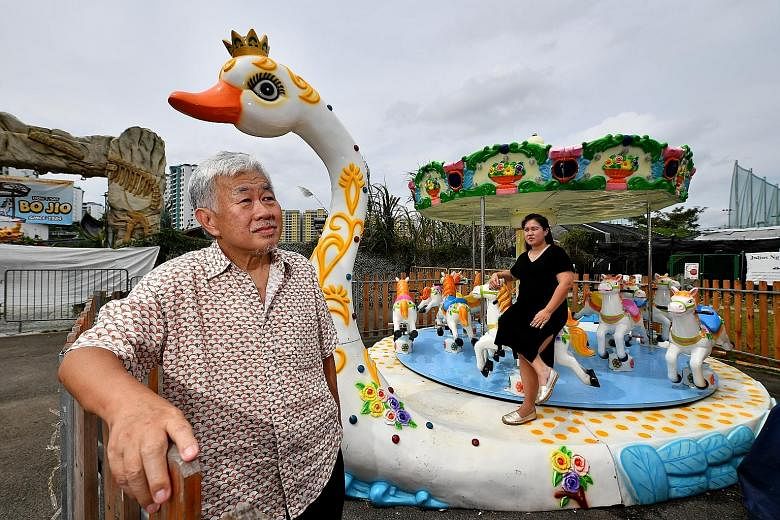 Mr Lee Woon Chiang, founder of Uncle Ringo, with his daughter Joyce at their fun fair at the Social Innovation Park in Punggol on Friday. Their plans last year to take a travelling circus to the heartland and to hold large-scale carnivals in China ha
