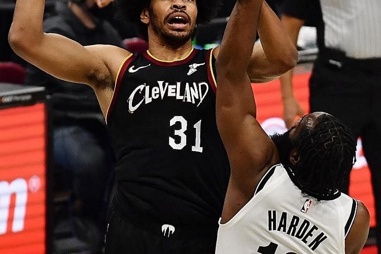 Cleveland centre Jarrett Allen, formerly from Brooklyn, shoots over the Nets' new guard James Harden's outstretched arm. Both had 19 points as the Cavaliers beat the Nets for the second time in three days.