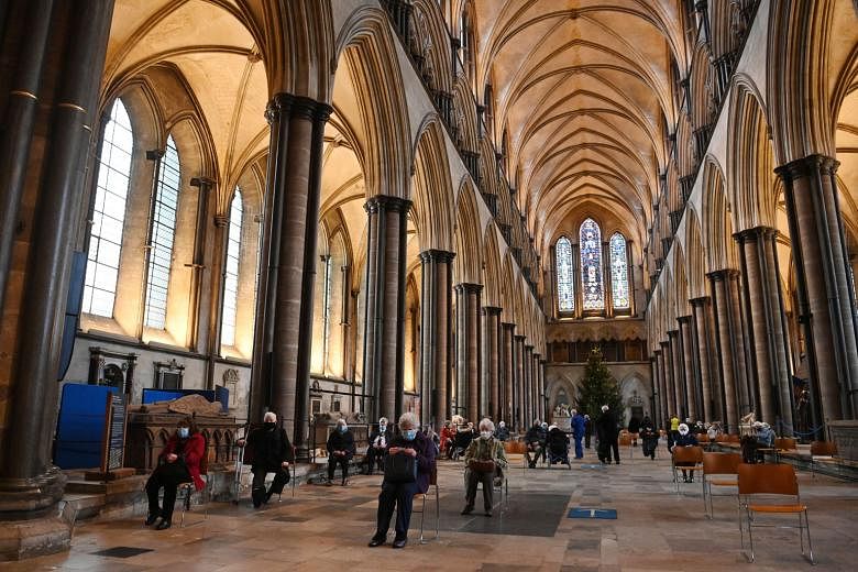 People resting in a waiting area after getting the Pfizer-BioNTech vaccine at Salisbury Cathedral in Britain. Prime Minister Boris Johnson said the country may need to roll out additional measures to safeguard its borders from new Covid-19 variants.