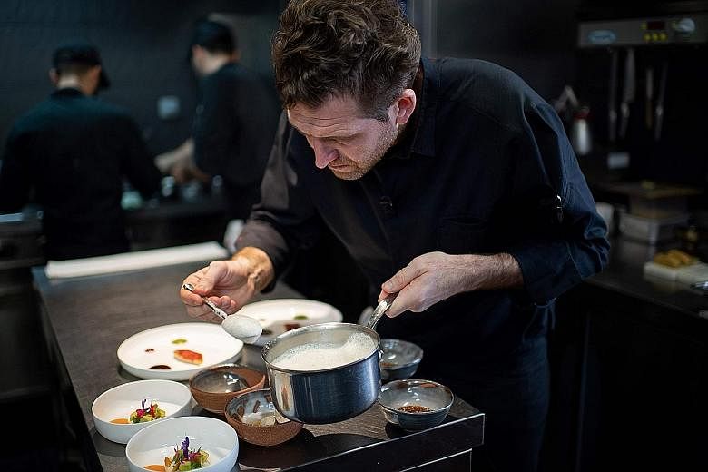 Chef Alexandre Mazzia preparing a dish at his restaurant AM in Marseille, southern France. It received its third Michelin star this year to enter the upper echelons of French gastronomy
