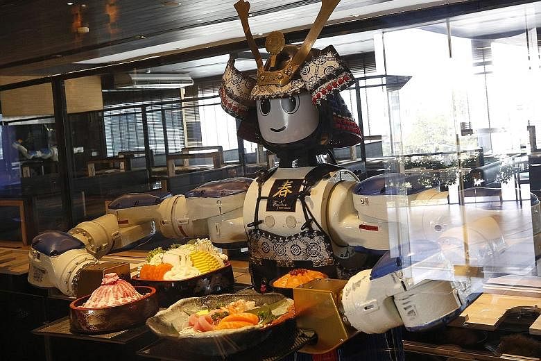 A robot serving customers earlier this month at Hajime Robot Restaurant, a Japanese eatery in Bangkok. As robots play a greater role in society, we will need to adapt our laws to accommodate them. As long as there is transparency and we maintain huma