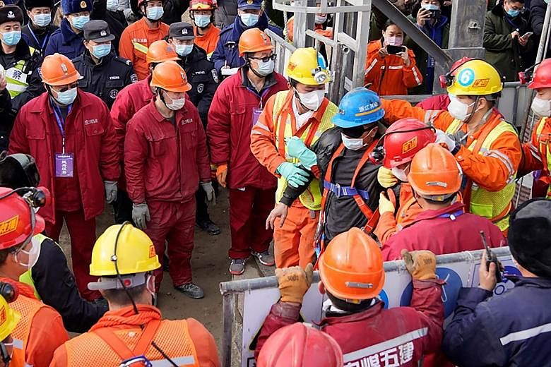 One of the miners at the Hushan mine in Shandong province being taken to safety on Sunday. A blast at the mine on Jan 10 trapped 22 miners hundreds of metres underground. Eleven miners have been pulled out alive from the mine, while 10 have died. The