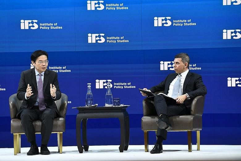 Education Minister Lawrence Wong speaking at a dialogue chaired by Straits Times editor Warren Fernandez as part of the Institute of Policy Studies' Singapore Perspectives conference yesterday. 
