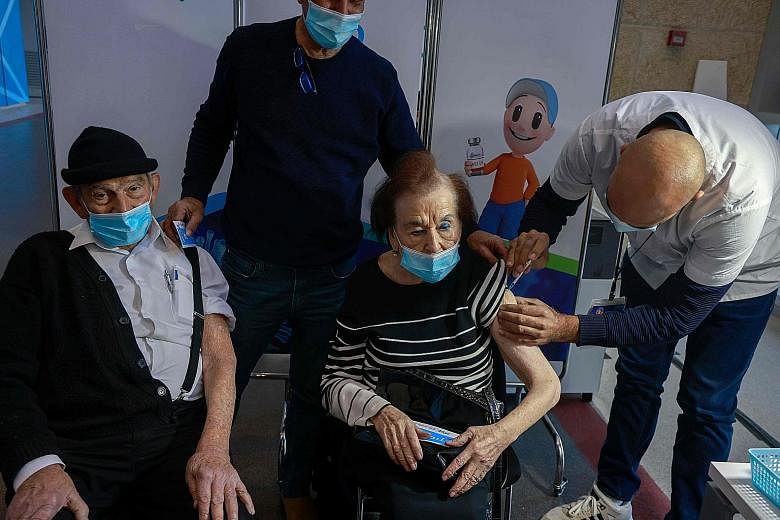 A woman receiving a dose of the Pfizer-BioNTech vaccine at Clalit Health Services in Jerusalem on Sunday. The Israeli Health Ministry found that out of 428,000 Israelis who had received their second doses, only 63 - or 0.014 per cent - contracted the