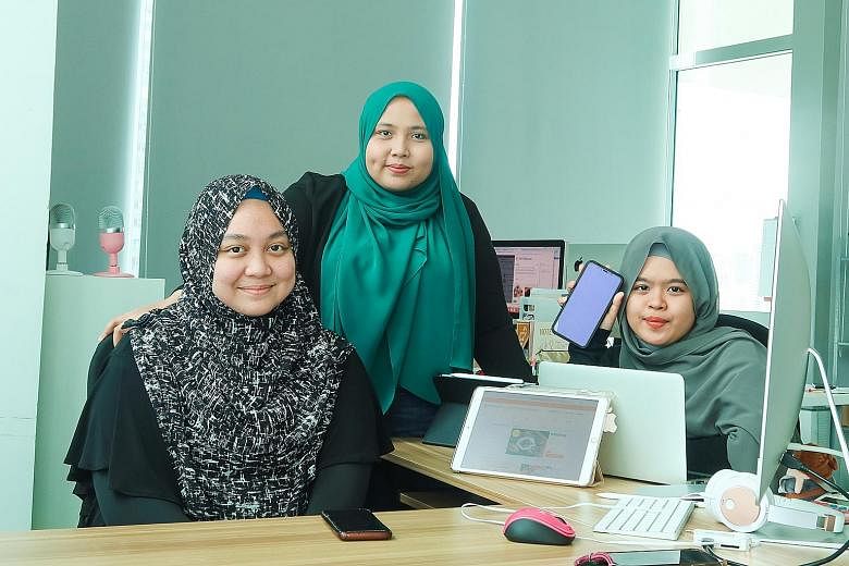 Halalfoodhunt chief executive and co-founder Jumaiyah Mahathir (centre), 31, flanked by managing assistant Nur Sarah Razali (left), 24, and sales executive Nur'Adriana Maisarah Abdul Rani, 21, at their office in Jalan Besar. In 2019, the company tapp