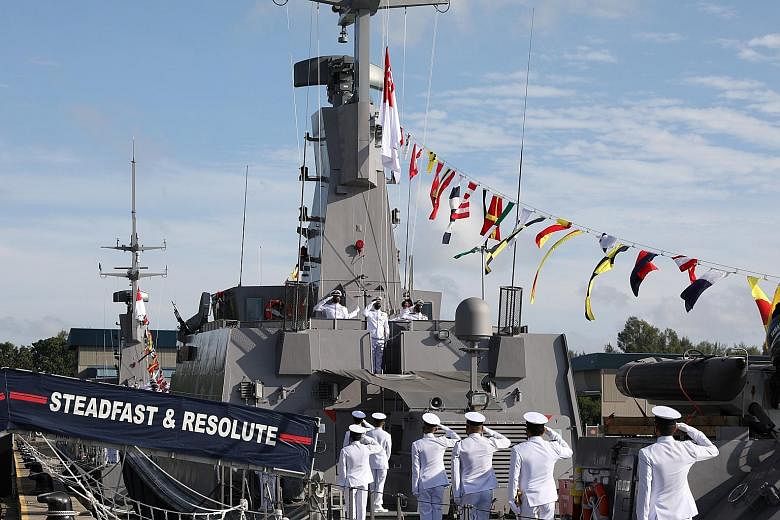 The crew of the Maritime Security and Response Vessel Guardian saluting as the naval ensign was raised at the Maritime Security and Response Flotilla's inauguration ceremony at RSS Singapura-Changi Naval Base yesterday. The flotilla's four Sentinel-c