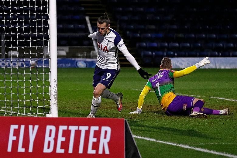 Gareth Bale celebrates nodding in Tottenham's equaliser against Championship side Wycombe. Spurs' 4-1 win earned them a trip to Goodison Park to play Everton in the fifth round of the FA Cup.