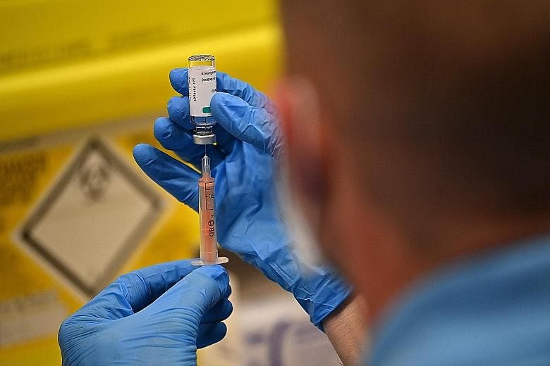 A healthcare professional drawing a dose of the Oxford-AstraZeneca Covid-19 vaccine at a vaccination centre in Brighton, southern England.