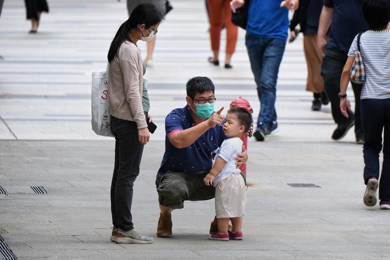 A father talking to his child as his wife looks on at Paya Lebar Central, on Sept 15, 2020.
