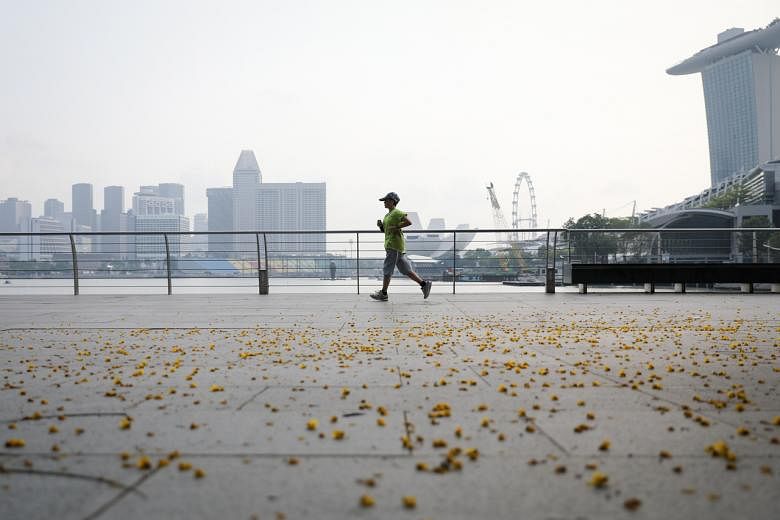 A runner jogging near The Promontory in Marina Bay area, on Aug 16, 2018.