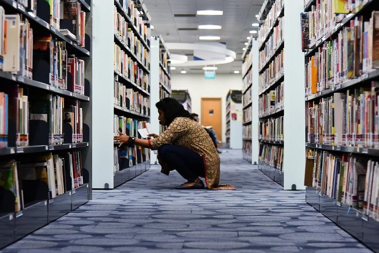 A woman browses books at the National Library on July 23, 2018.