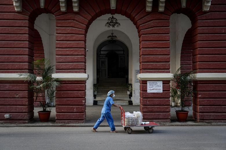 A staff member pushes a food trolley to deliver breakfasts at the Yangon General Hospital, in Yangon, Myanmar, on Jan 24, 2021.