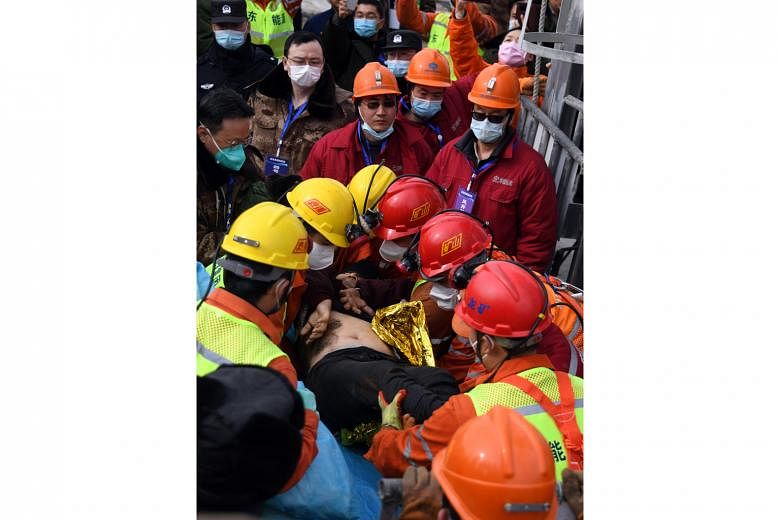 One of the miners at the Hushan mine in Shandong province being taken to safety yesterday. A blast at the mine on Jan 10 trapped 22 miners about 600m underground. One miner is known to have died and 10 are unaccounted for. 