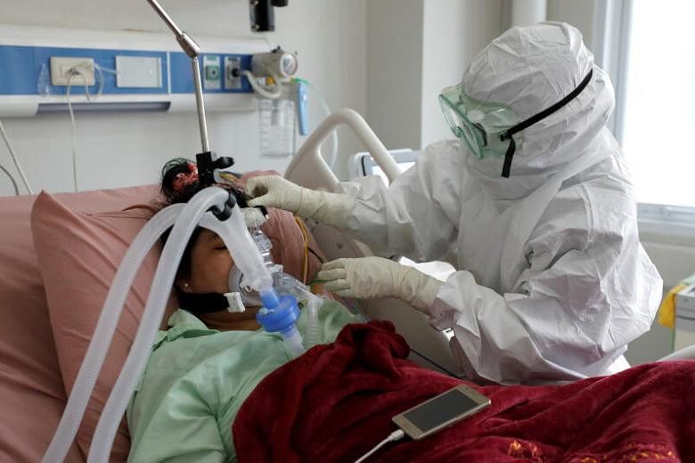 A nurse assisting a patient suffering from Covid-19 in the ICU of a hospital in Bogor, Indonesia, on Jan 26, 2021.