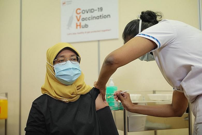 President Halimah Yacob getting her Covid-19 vaccine jab on the sidelines of a visit to Outram Polyclinic yesterday. Prime Minister Lee Hsien Loong visiting Ang Mo Kio Polyclinic, where vaccinations for seniors started yesterday. PM Lee said he will 