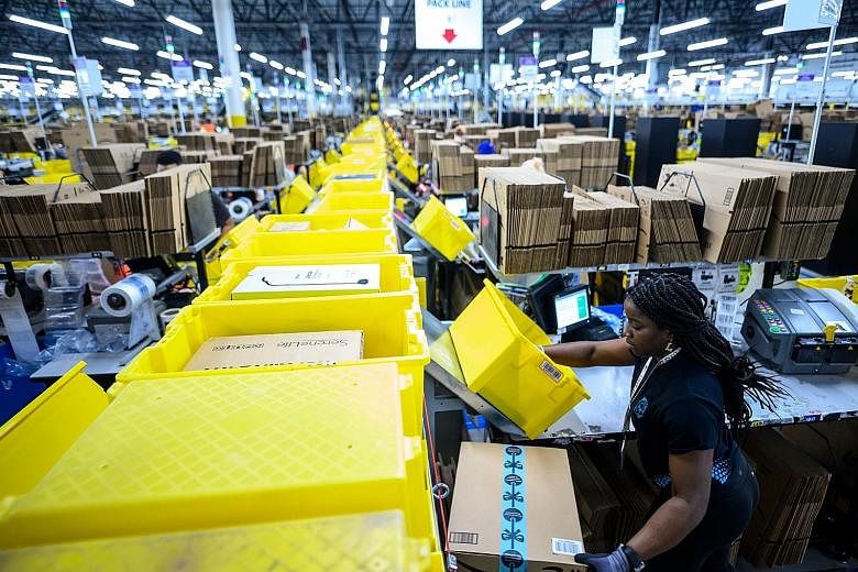 A worker at the Amazon fulfilment centre in Staten Island, New York City, in 2019. Enterprise Singapore is in talks with the e-commerce giant on training programmes to help local SMEs sell overseas via Amazon.