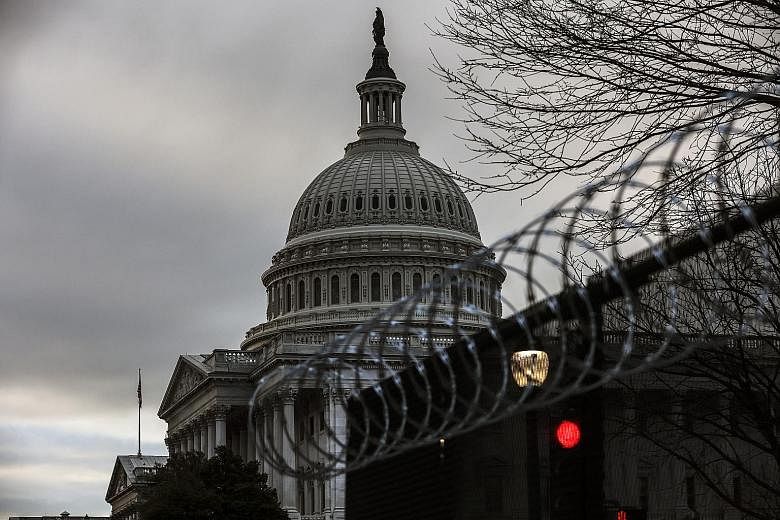 Security fencing topped with razor wire surrounding the United States Capitol in Washington. The Department of Homeland Security's terrorism alert said extremists emboldened by the deadly Jan 6 assault on Congress by angry supporters of former presid
