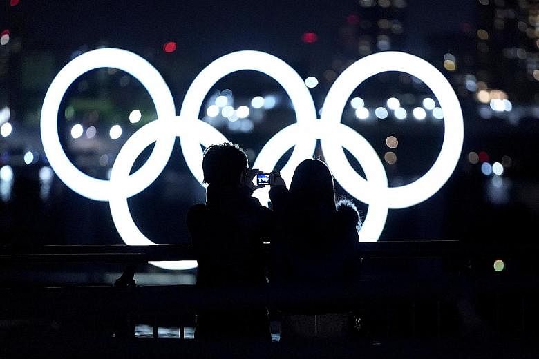 The Olympic rings are lit up off Odaiba island in Tokyo. While Japan's infection count has been well below other industrialised nations, the pandemic has been a persistent cloud over the Olympics since they were delayed almost a year ago.