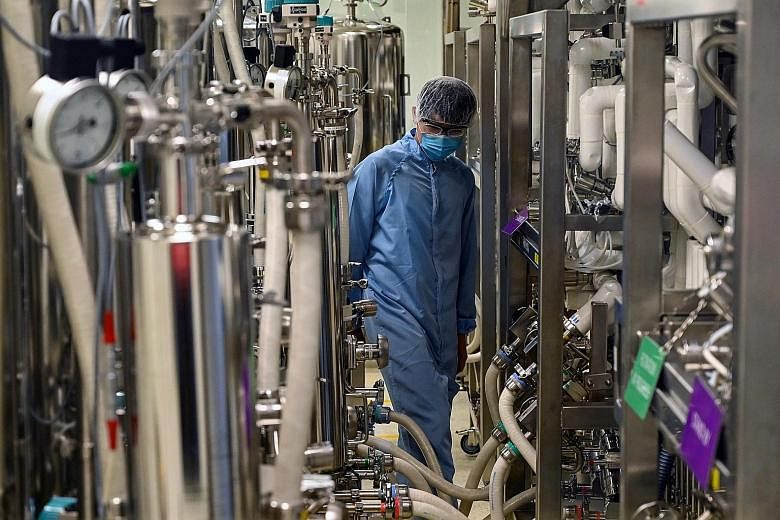 A biochemist in a buffer preparation room used for manufacturing medical products at Takeda Pharmaceuticals here. All manufacturing clusters anticipate better business prospects in the first half of this year, with the biomedical manufacturing cluste
