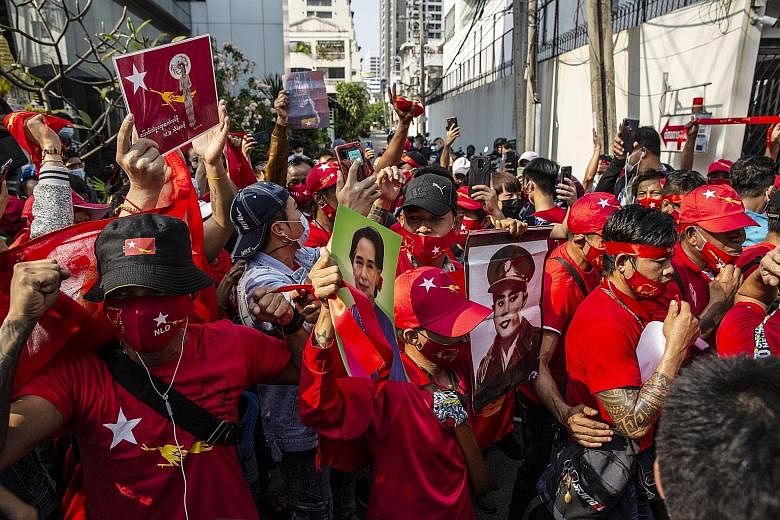 Demonstrators holding up images of National League for Democracy leader Aung San Suu Kyi and her late father, General Aung San, at a protest outside the Myanmar Embassy in Bangkok yesterday. Political analyst Soe Myint Aung expects the NLD to survive