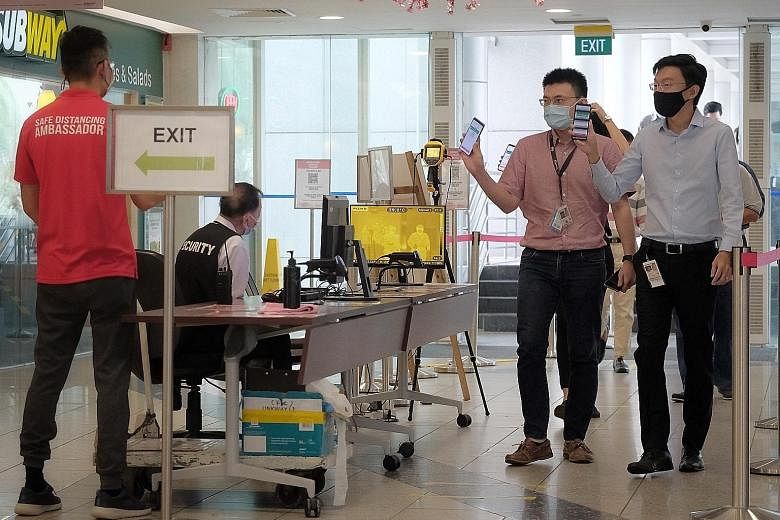 People using SafeEntry and TraceTogether to enter HarbourFront Centre yesterday. While 350 people have asked for their contact tracing data to be erased from the Government's server in the last month, Minister-in-charge of the Smart Nation Initiative