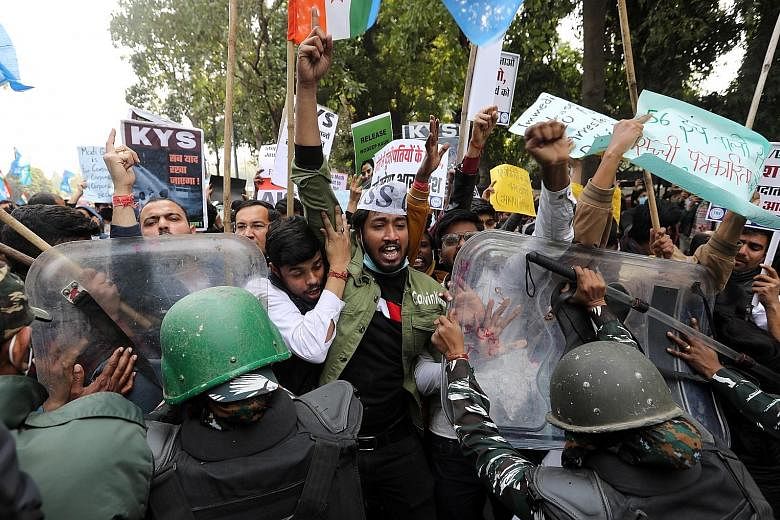 Protesters and security personnel clashing during a demonstration in solidarity with Indian farmers in New Delhi on Wednesday. PHOTO: EPA-EFE