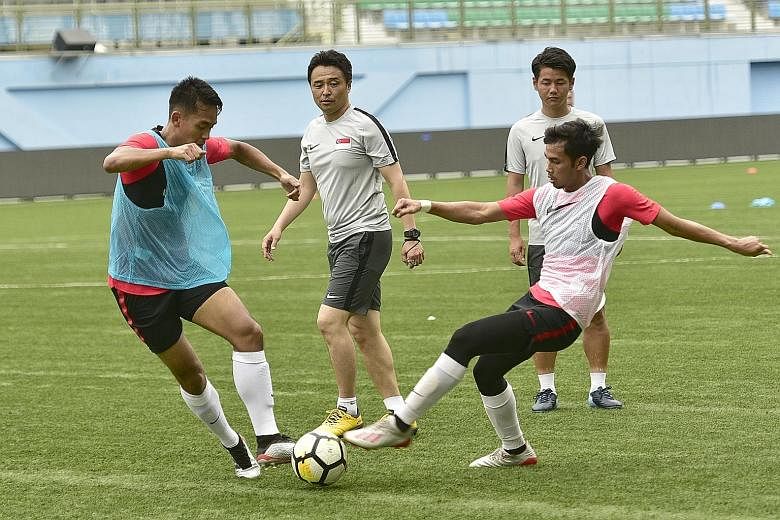 Singapore players have benefited from the training methods of Tatsuma Yoshida (centre), according to national captain Hariss Harun.