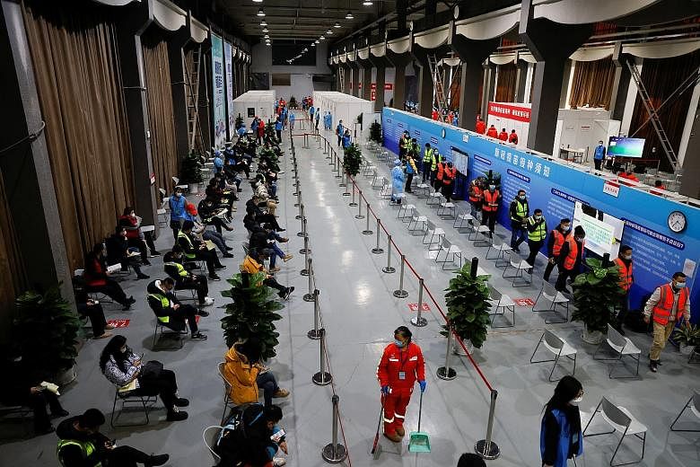 A vaccination centre (below) in Beijing last month. As vaccinations are being administered more rapidly in wealthier Western countries, such nations are likely to beat Covid-19 much sooner than poorer nations and those with massive populations, such 