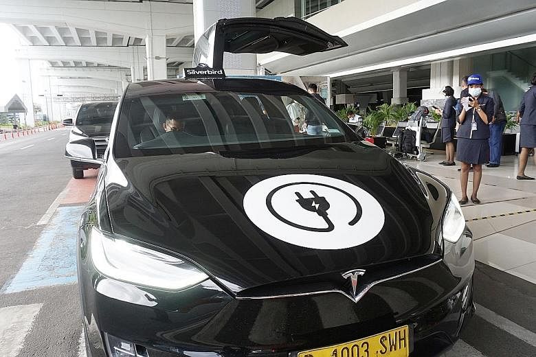 A Tesla model X airport taxi outside Jakarta's Soekarno-Hatta International Airport last December. The US electric car company plans to invest in factories in Indonesia to make electric vehicle lithium batteries and power generators. PHOTO: AGENCE FR