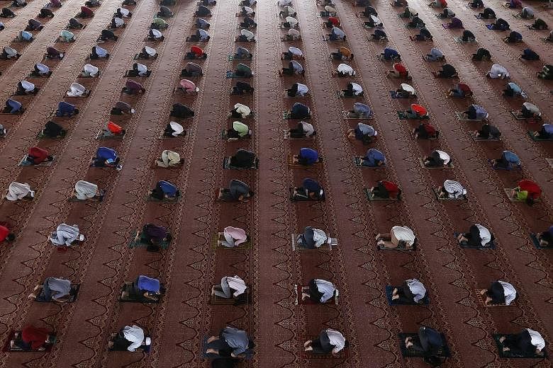 Muslims observing social distancing while attending Friday prayers at a mosque in Putrajaya, outside Kuala Lumpur, last week. Malaysia, which is battling its third wave of the virus, is expected to receive its first batch of vaccines on Feb 26, after