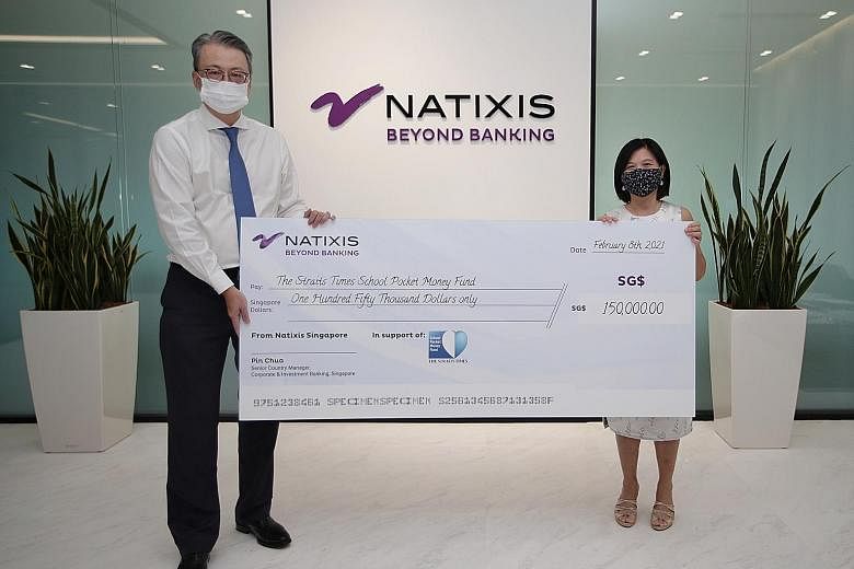 Mr Pin Chua, Natixis' senior country manager of Singapore and head of South-east and South Asia for corporate and investment banking, presenting the financial services firm's donation to The Straits Times School Pocket Money Fund's general manager Ta