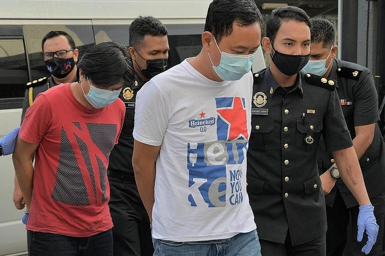 Yong Chee Keong (left) and Chong Kim Kuang, respectively the director and manager of a frozen food firm based in Senai, Johor, are accused of using fake halal logos on dozens of packages of meat not certified to be halal.