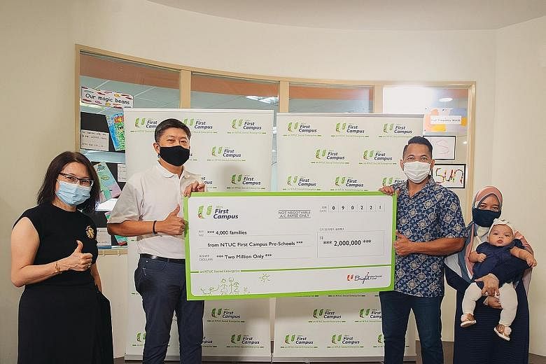 Mr Mustakem Muhamed Rais (third from left), flanked by his wife Diana Abu Bakar and six-month-old daughter Nur Thahirah Mustakem, receiving the $2 million contribution to the NTUC initiatives, on behalf of beneficiaries, from NTUC secretary-general N