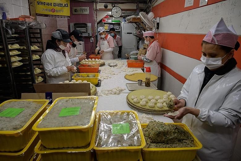 Workers making dumplings in a restaurant in Seoul in November. Last month, the sector in South Korea combining retailers, wholesalers, restaurants and hotels was hit the hardest, with 585,000 job losses from a year earlier.