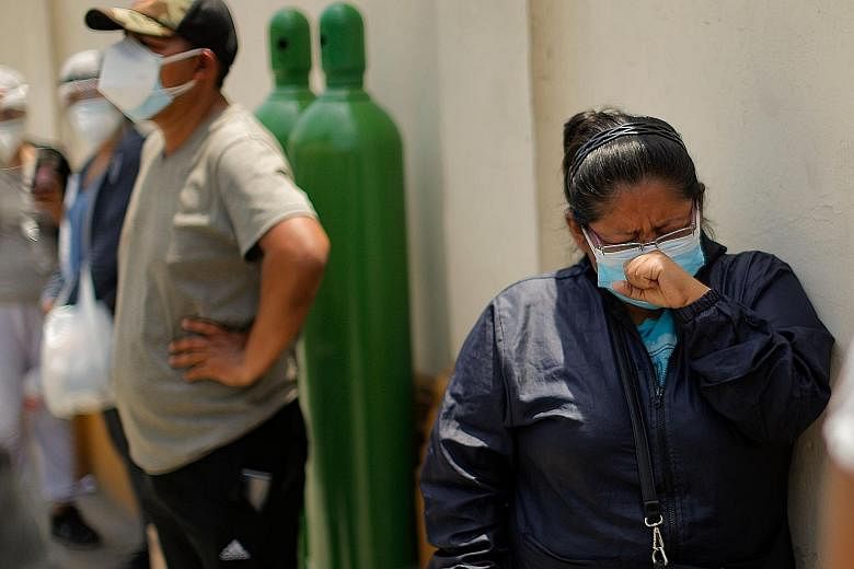 Relatives of Covid-19 patients queueing to refill oxygen tanks in Lima, Peru on Tuesday. As demand for oxygen soars across Latin America, prices have skyrocketed. PHOTO: AGENCE FRANCE-PRESSE