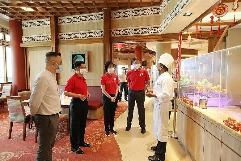 Deputy Prime Minister and Finance Minister Heng Swee Keat (second from left) meeting executive sous chef Pradeep Kumar and other staff at Shangri-La's Rasa Sentosa Resort & Spa to find out how the various Budget measures have helped them. With him ar